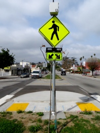 New crosswalk with beg button activated warning beacons.